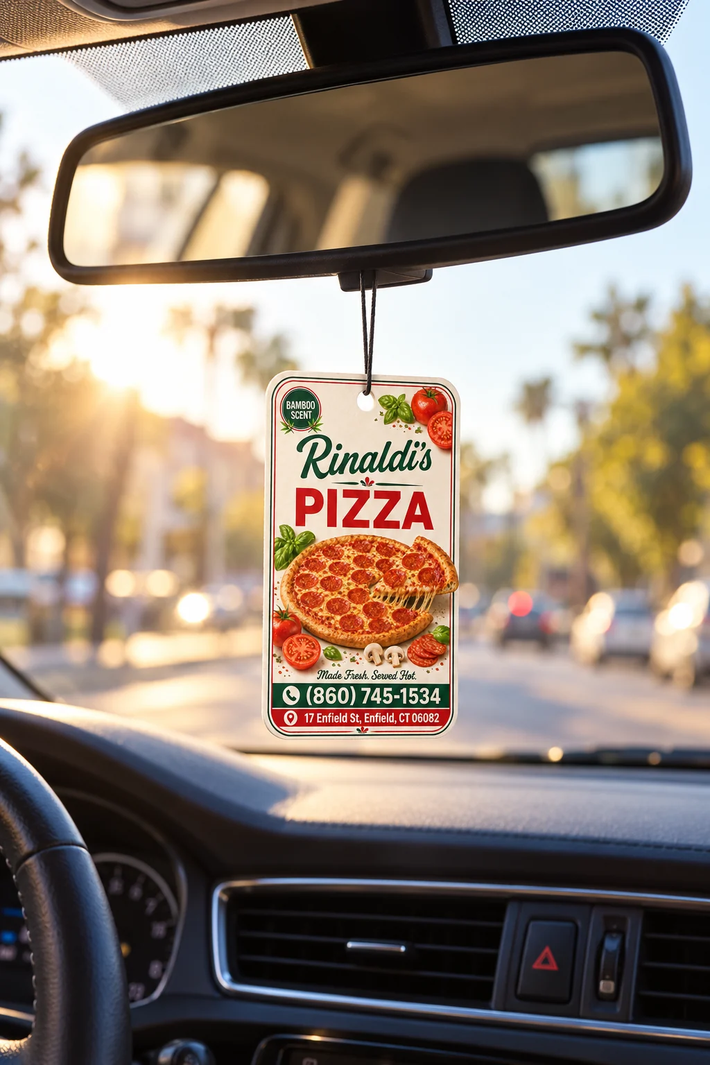 Rinaldi’s Pizza custom air freshener hanging from a car rearview mirror